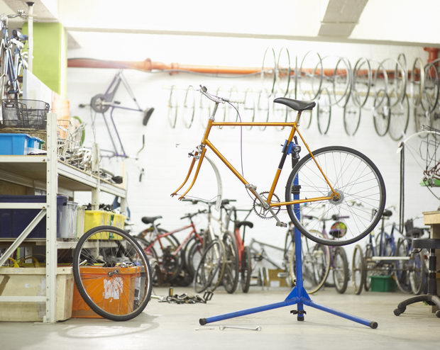 Bicycle on stand in workshop.