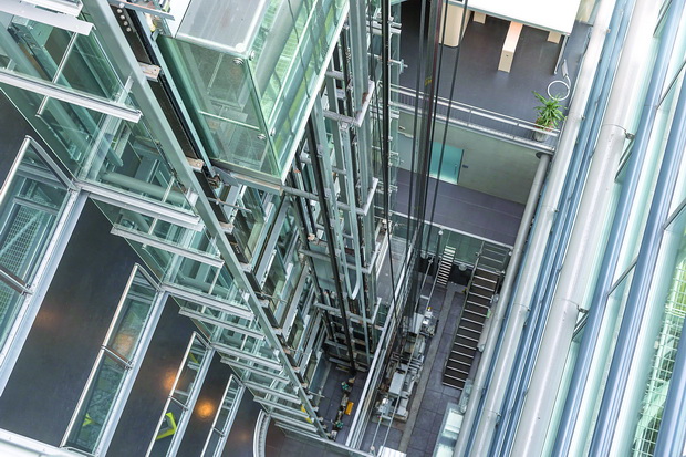 Looking downwards in a modern open elevator shaft