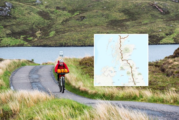 Lonely female biker cycling through the Scottish Highlands.