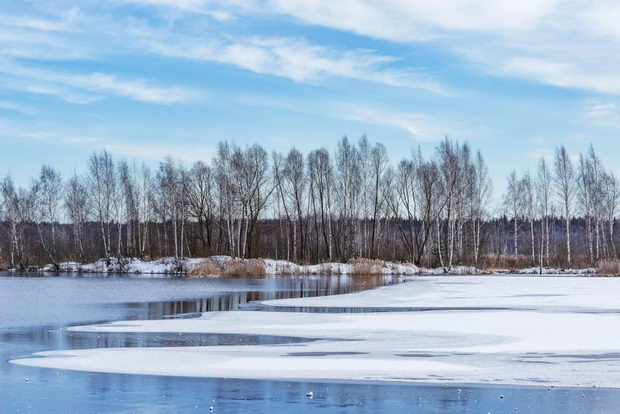 Melting ice on the lake at early springtime.