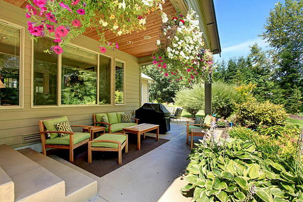 Cozy backyard concrete floor patio area with table set. Northwest, USA