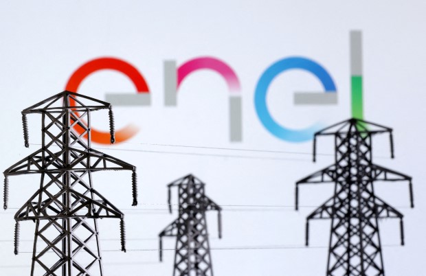 FILE PHOTO: Illustration shows Electric power transmission pylon miniatures and Enel logo